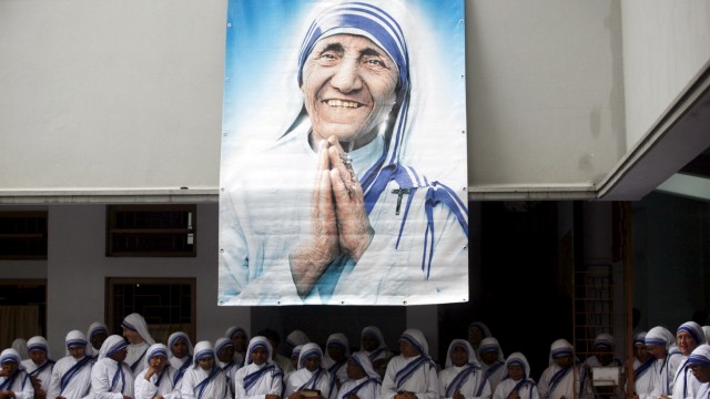 File photo of Catholic nuns from the order of the Missionaries of Charity gather under a picture of Mother Teresa in Kolkata