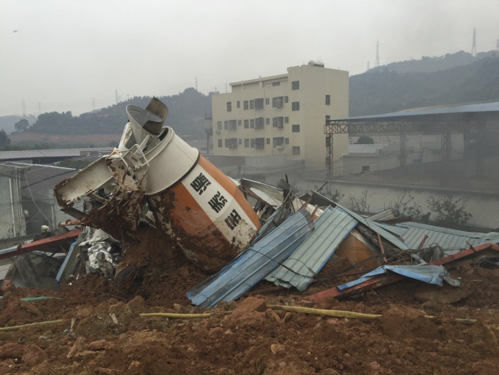 A damaged vehicle is seen among the debris at the site of a landslide at an industrial park in Shenzhen