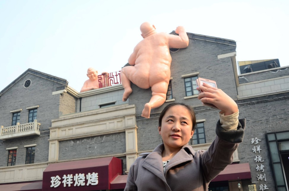 JINAN CHINA DECEMBER 20 CHINA OUT Two giant naked sculptures appear on the side of a restauran
