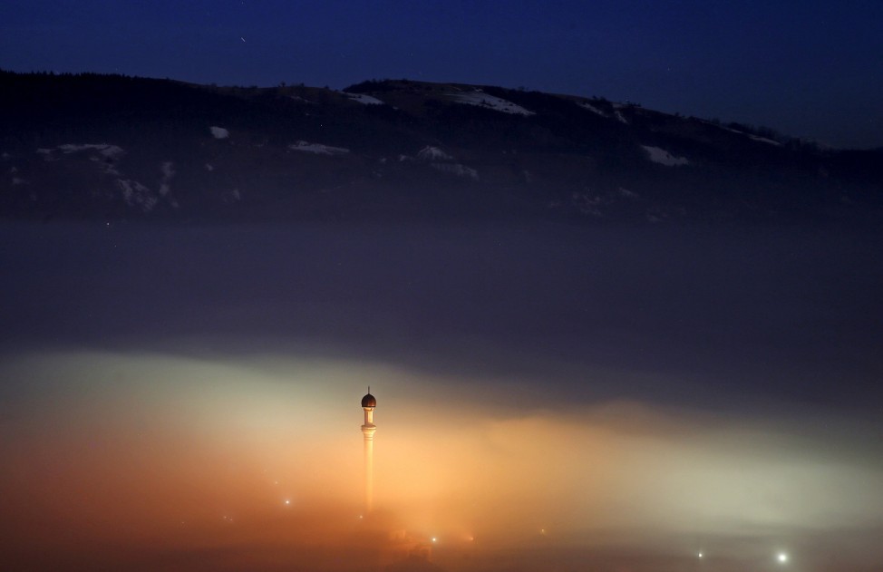 The minaret of a mosque is seen as smog blankets the village of Ponijeri, Bosnia and Herzegovina