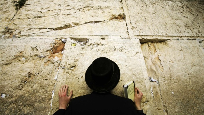 An Ultra Orthodox Israeli Jew prays at Jerusalem's Western Wall in solidarity for residents of south Israel