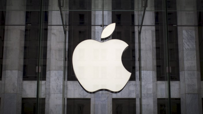 File photo of an Apple logo hanging above the entrance to the Apple store on 5th Avenue in the Manhattan borough of New York City