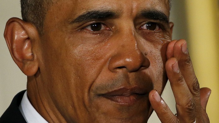 U.S. President Barack Obama wipes tears while delivering a statement on steps the administration is taking to reduce gun violence in the East Room of the White House in Washington