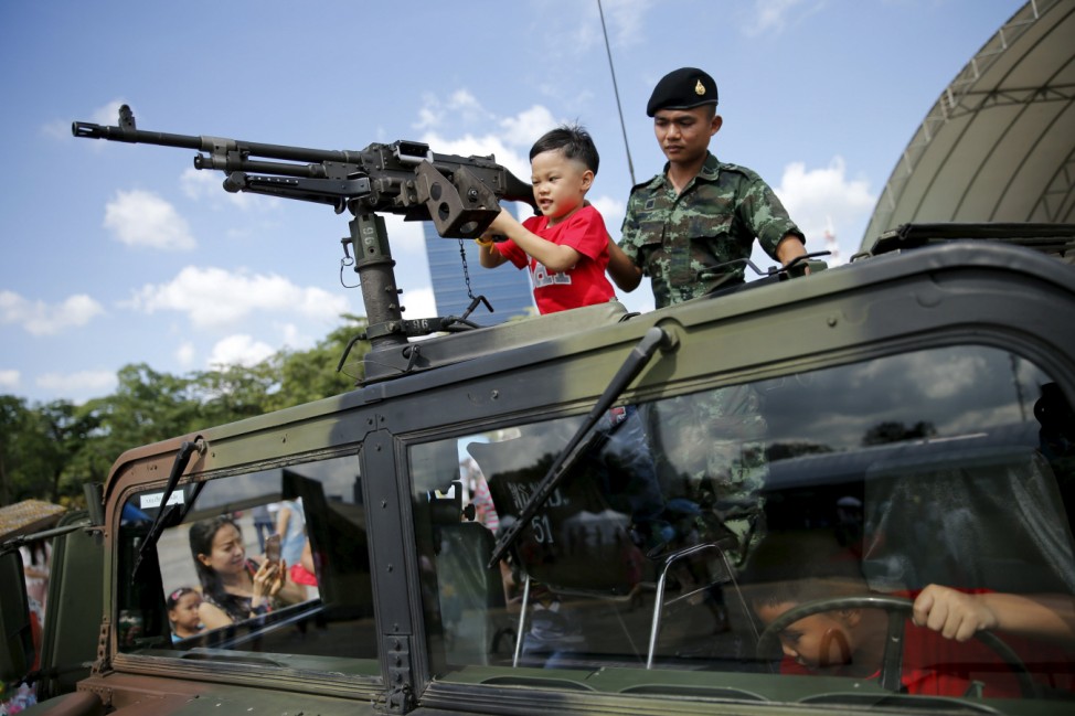 Children play in a military vehicle during the Children's Day celebration in Bangkok