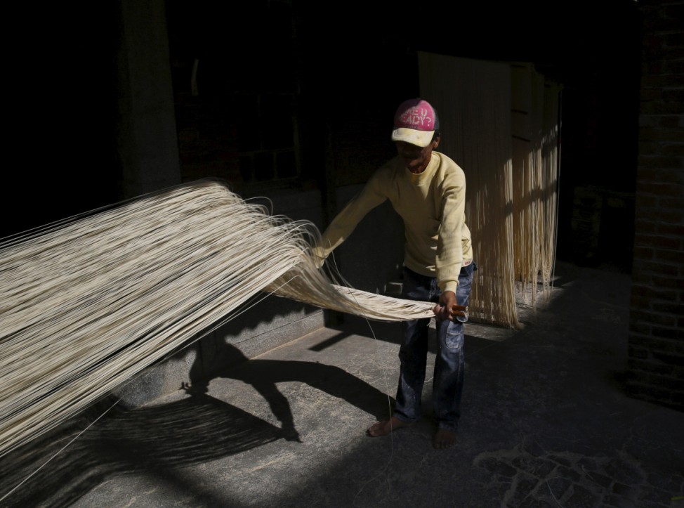 A man dries handmade noodles in the sunlight in Fuxing town, Changhua County, Taiwan