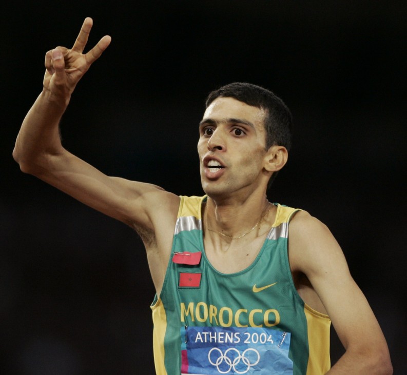 Moroccos Hicham El Guerrouj celebrates his two gold medals after winning the mens 5,000 metres final in Athens