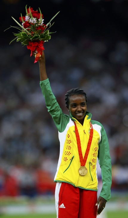 Women's 10,000m gold medallist Dibaba of Ethiopia waves on podium during the medal ceremony in the National Stadium at the Beijing 2008 Olympic Games