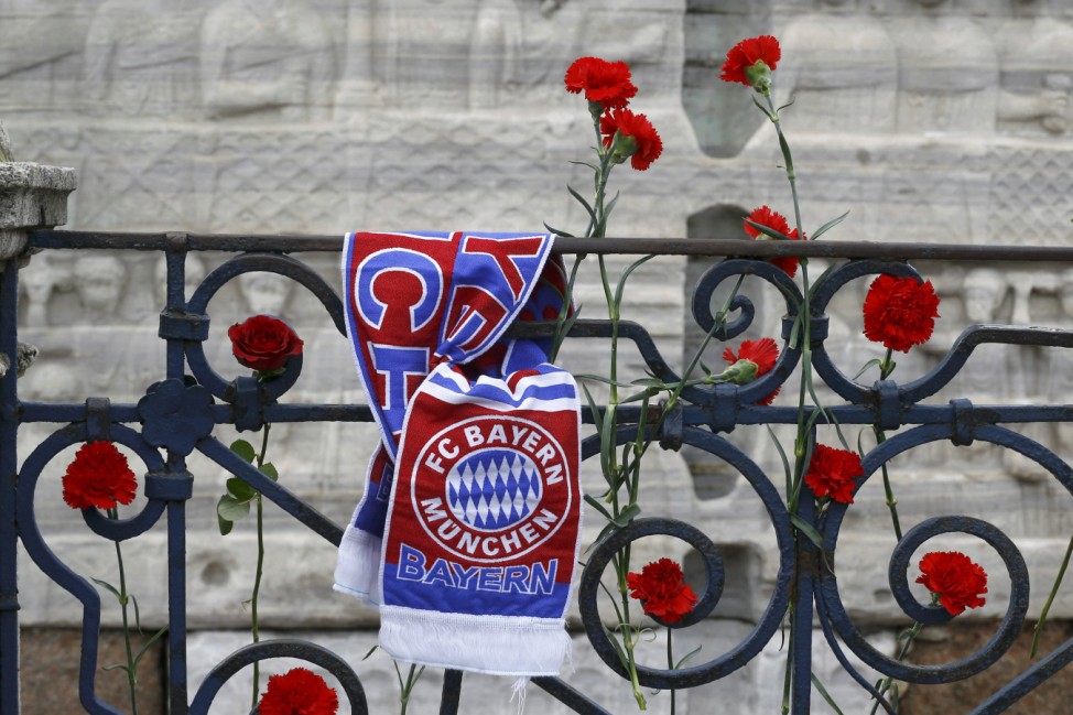 A Bayern Munich football club scarf is tied to a railing next to flowers at the Obelisk of Theodosius at Sultanahmet square in Istanbul