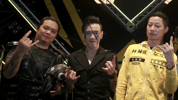 Freddy Lim, a candidate to the 2016 legislative election and singer of death metal band Chthonic, and members of Chthonic pose for photographers during an interview with reporters after a concert to boost his campaign in Taipei