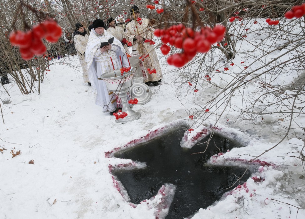 Priests take part in a religious ceremony during Orthodox Epiphany celebrations in Kiev