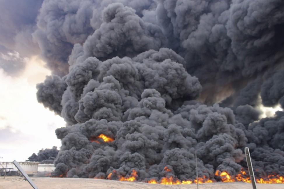 Smoke rises from a fire from an oil tank at the port of Ras Lanuf