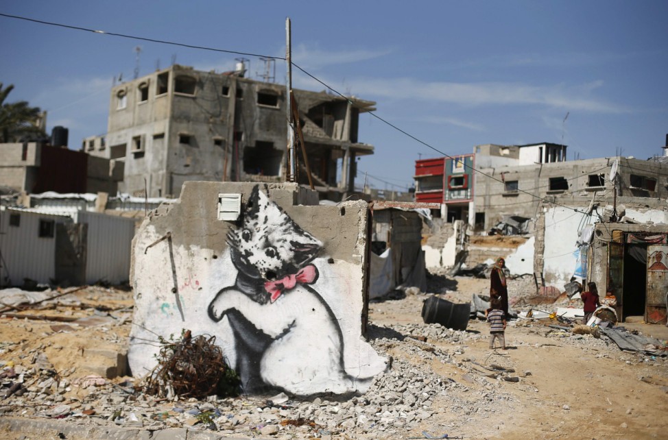 A mural of a kitten, presumably painted by British street artist Banksy, is seen on the remains of a house in Biet Hanoun
