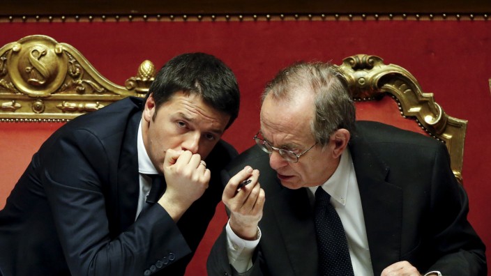 File photo of Italy's PM Renzi talking with Finance Minister Padoan during a confidence vote at the Senate in Rome