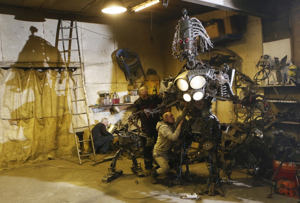 Mechanic and welder Kulagin and his collegues work on electro-mechanical robot made with used car components in Divnogorsk outside Krasnoyarsk