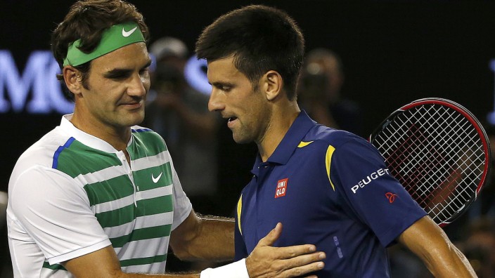 Serbia's Djokovic and Switzerland's Federer shake hands at the net after Djokovic won their semi-final match at the Australian Open tennis tournament at Melbourne Park