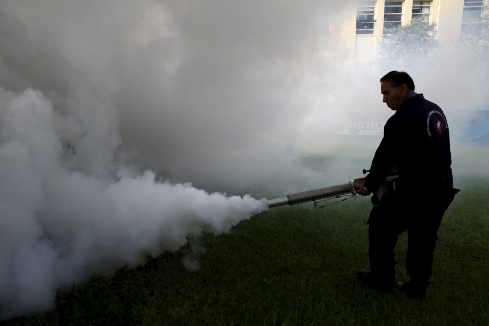 A health worker demonstrates fumigation to the press during a campaign to raise awareness of preventing the entry of the Zika virus into the country, at the Health Ministry in Lima