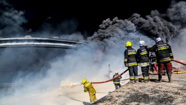 File picture shows firefighters trying to put out a fire in an oil tank in the port of Es Sider, in Ras Lanuf, Libya