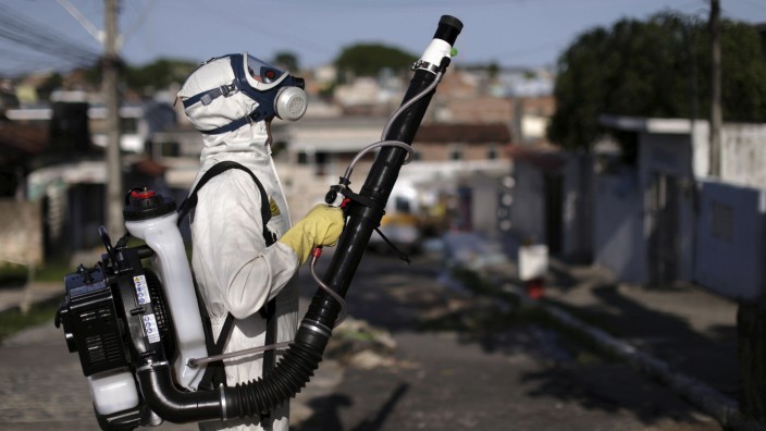 A municipal worker sprays insecticide at the neighborhood of Afogados in Recife