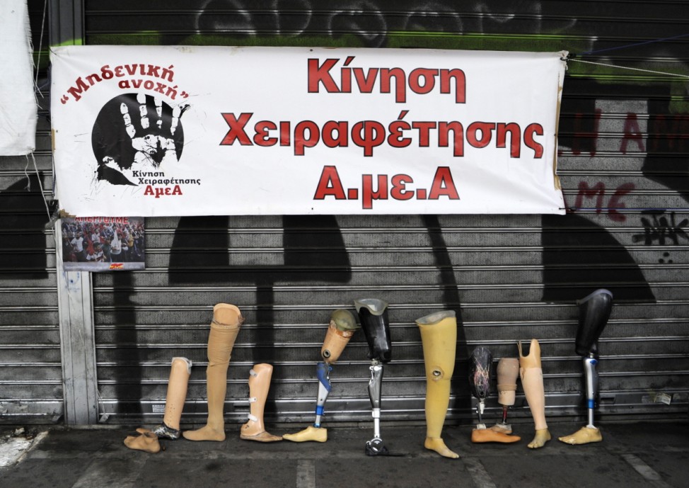 Prosthetics are placed in front of the Labour Ministry by disabled Greeks during a 24-hour general strike against planned pension reforms in Athens
