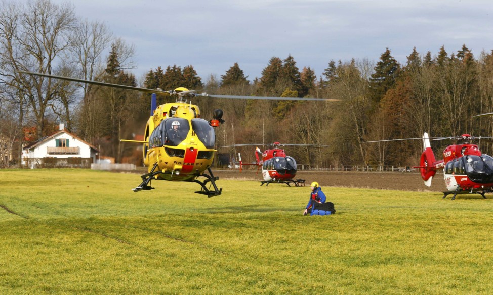 Helicopters of rescue services are seen at a field near Bad Aibling