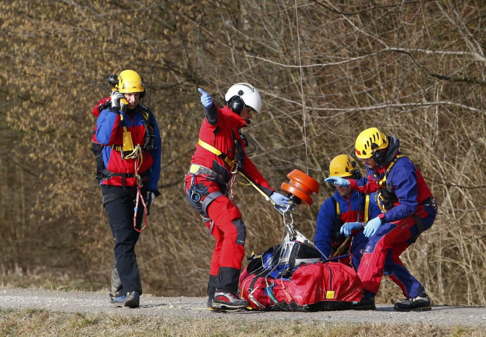 Members of emergency services prepare an injured person for transportation by helicopter from the site of the two crashed trains near Bad Aibling
