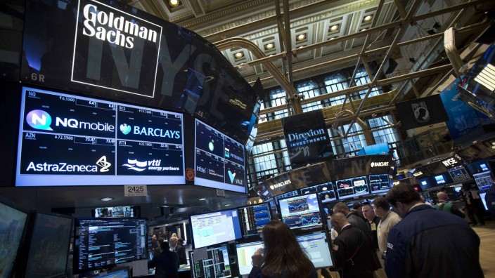 File photo of the Goldman Sachs logo on their post as traders work on the floor of the New York Stock Exchange in New York