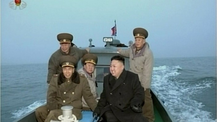 Still image taken from video shows North Korean leader Kim Jong-un travelling with senior military officials on a boat at an undisclosed location