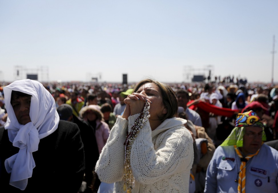 People participate in a Pope Francis's Mass for a crowd of hundreds of thousands in Ecatepec, Mexico