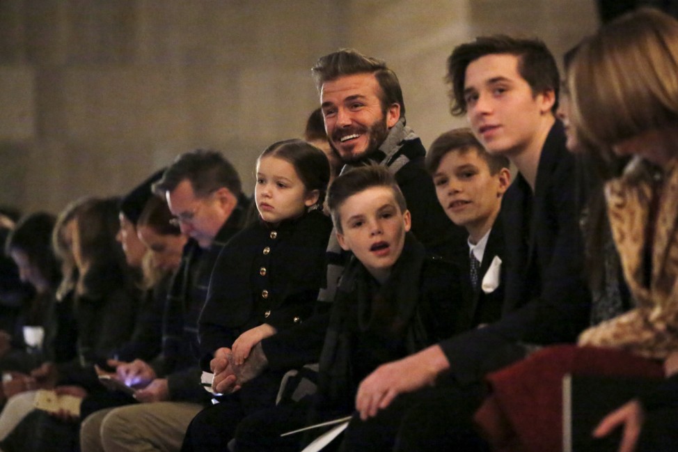 David Beckham sits in the front row at the Victoria Beckham Fall/Winter 2016 collection presentation with his children Harper, Cruz, Romeo and Brooklyn at New York Fashion Week.