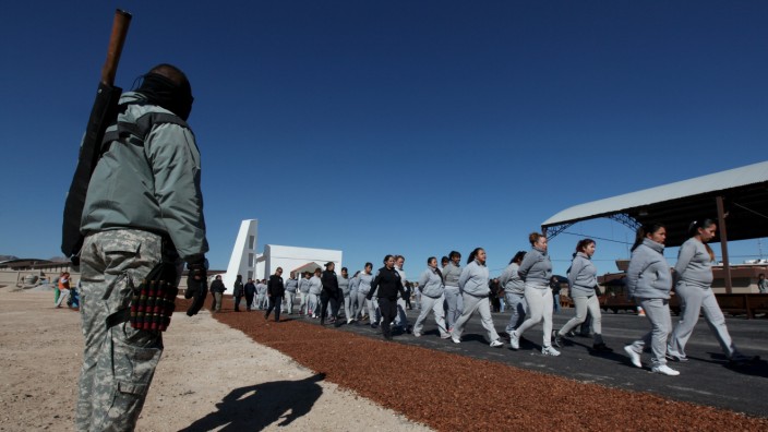 Policeman stands guard as female inmates return to their cells after a rehearsal of a song they will sing for Pope Francis in preparation for his upcoming visit to Cereso 3 prison in Ciudad Juarez