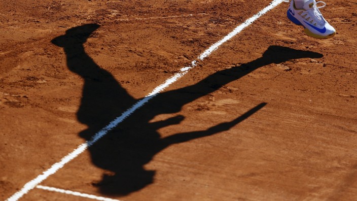 Spain's Nadal casts his shadow as he serves during his tennis match against Italy's Lorenzi at the ATP Argentina Open in Buenos Aires
