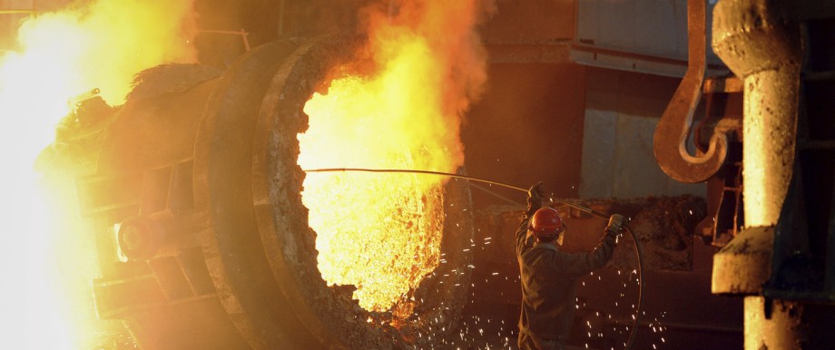 File photo of a steel worker operating a furnace at a steel manufacturing plant in Hefei