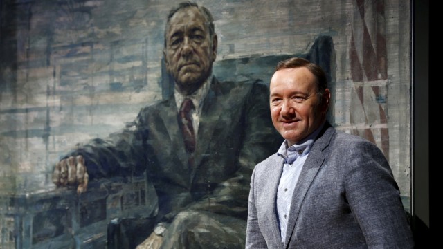 Actor Kevin Spacey beside his House of Cards portrait in Washington