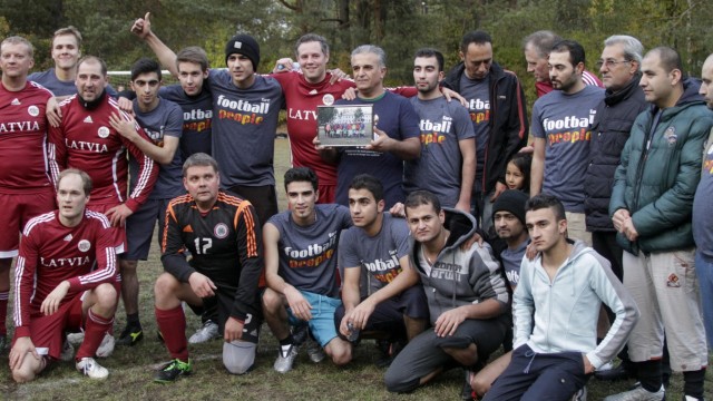 Refugees, MPs play soccer in Latvia