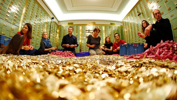 Committee members for 'Grundeinkommen' open rolls of five cent coins in the old vault of the former Schweizerische Volksbank in Basel