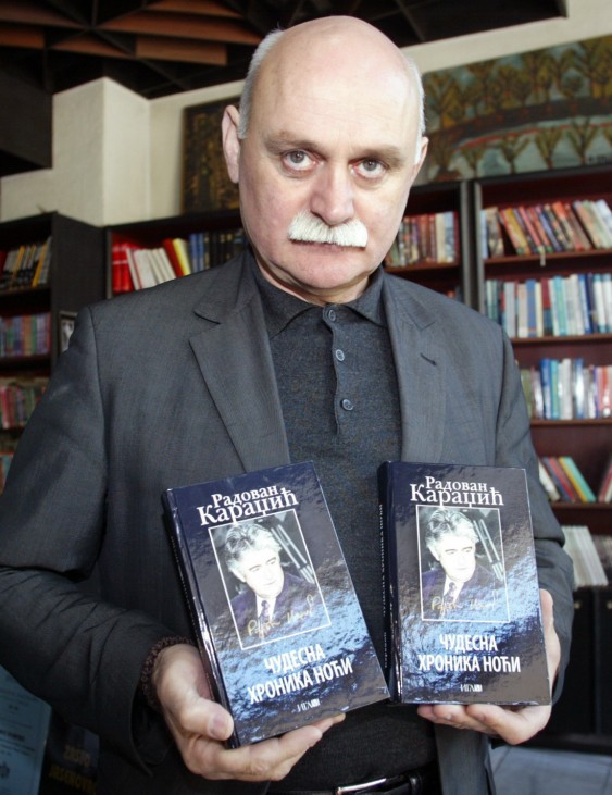 Karadzic displays a book of his brother Radovan Karadzic in Belgrade