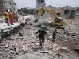 Rescue workers attempt to find survivors from the rubble of the collapsed Rana Plaza building in Savar