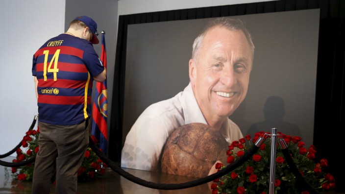 A man cries in front of a picture of Johan Cruyff during a memorial at Camp Nou stadium in Barcelona