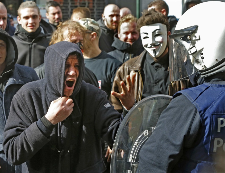Demonstrators protesting against wave of terrorism confront police in front of the old stock exchange in Brussels