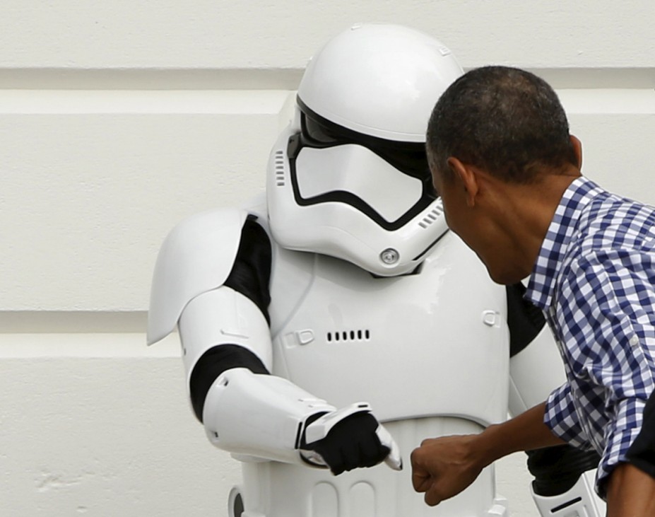 Obama fist bumps a costumed Stormtrooper from the Star Wars movies as he presides over the annual Easter Egg Roll at the White House in Washington