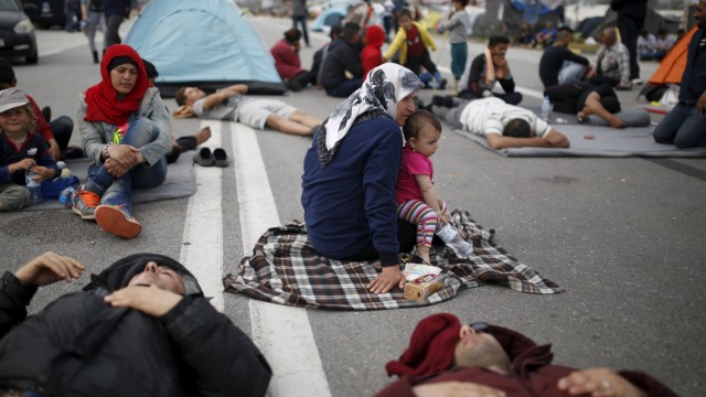 Migrants and refugees block the highway during a protest near the Greek-Macedonian border, near the town of Polykastro