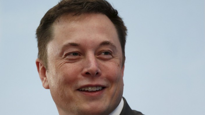 Tesla Chief Executive Elon Musk smiles as he attends a forum on startups in Hong Kong