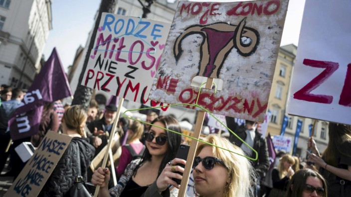People demonstrate against the Polish government's plan to tightening the abortion law in Krakow, Poland