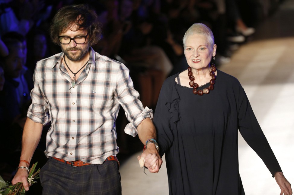 British designer Vivienne Westwood appears next to husband Andreas Kronthaler at the end of her Spring/Summer 2015 women's ready-to-wear collection during Paris Fashion Week