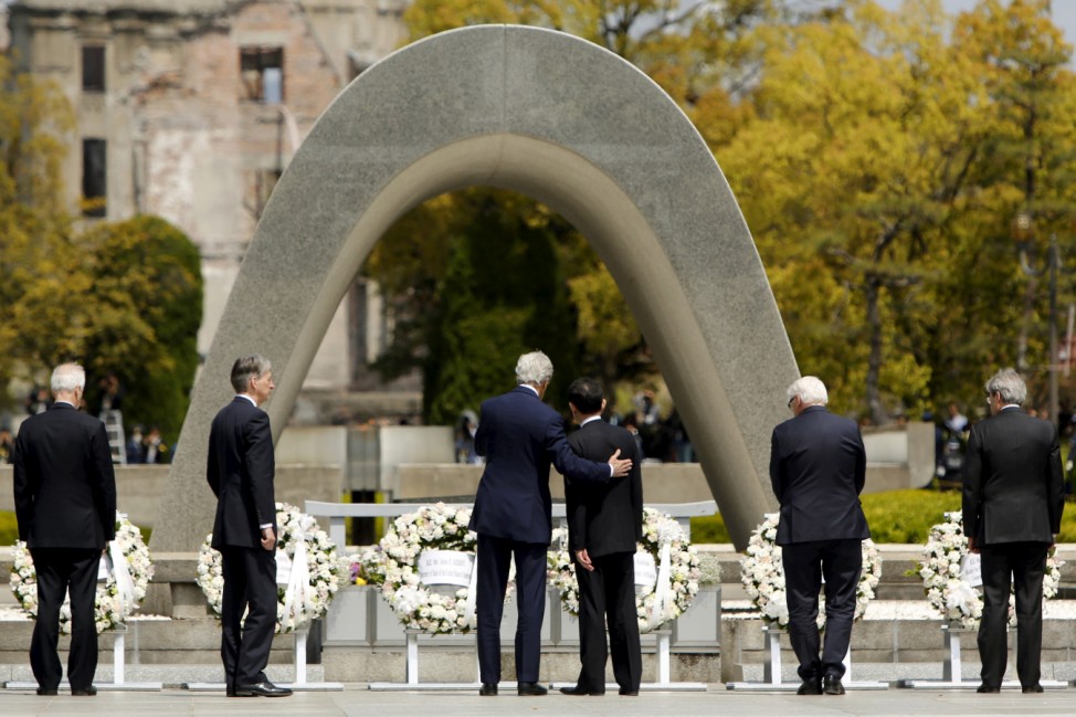 Kerry puts his arm around Kishida after they and fellow G7 foreign ministers laid wreaths at the cenotaph at Hiroshima Peace Memorial Park and Museum in Hiroshima, Japan