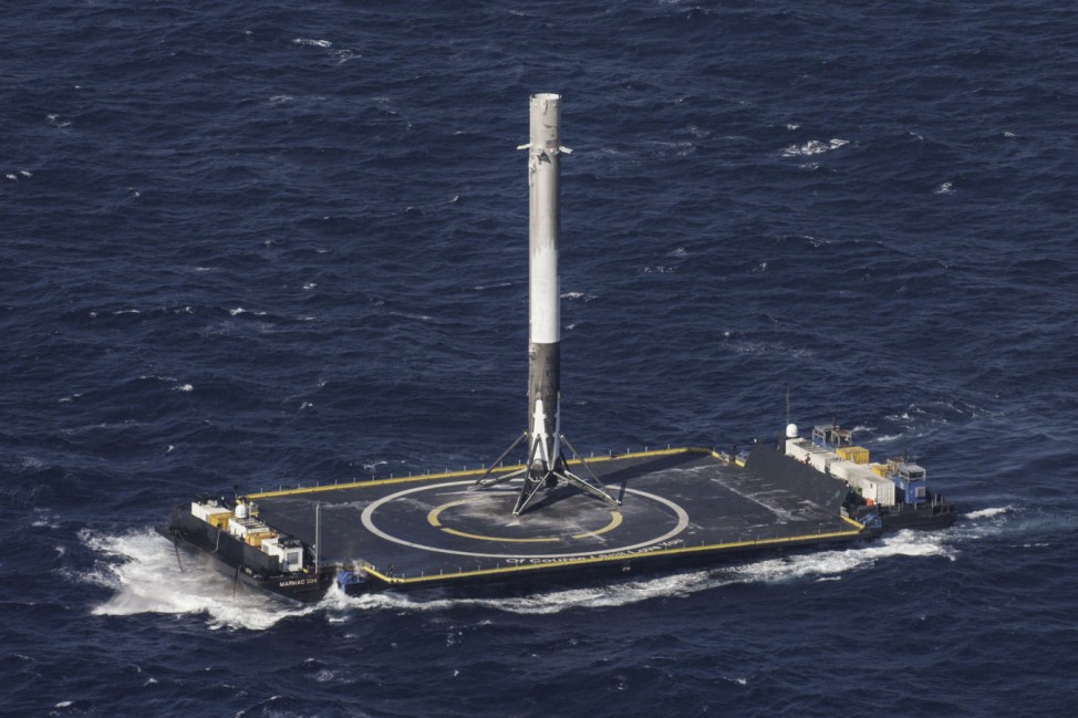Handout photo of the reusable main-stage booster from the SpaceX Falcon 9 makes a successful landing on a platform in the Atlantic Ocean about 185 Nautical miles off the coast of Florida