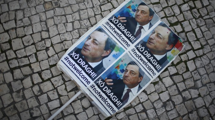 A placard is seen during a protest against the visit of European Central Bank (ECB) President Mario Draghi in Lisbon