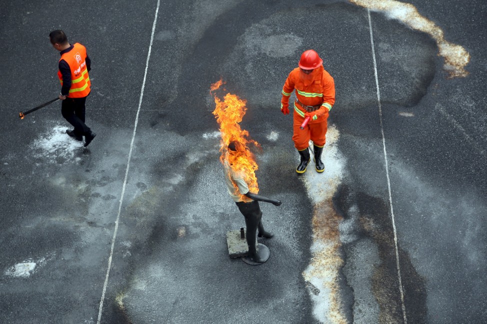 A dummy is set on fire at a fire awareness demonstration in Hangzhou