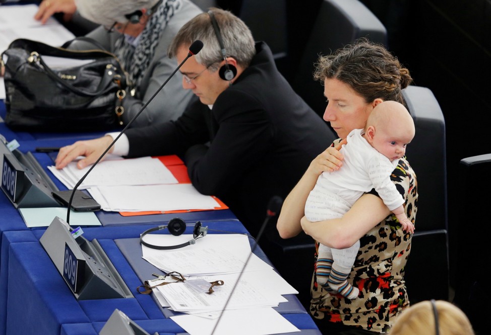 European Parliament Member Dodds of the UK holds her baby as she takes part in a voting session at the European Parliament in Strasbourg