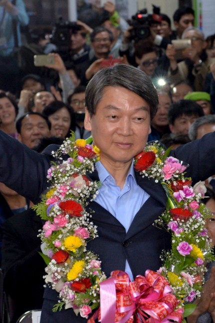 Ahn Cheol-soo, the minor opposition People's Party co-chairman, celebrates his victory in the parliamentary election at his office in Seoul